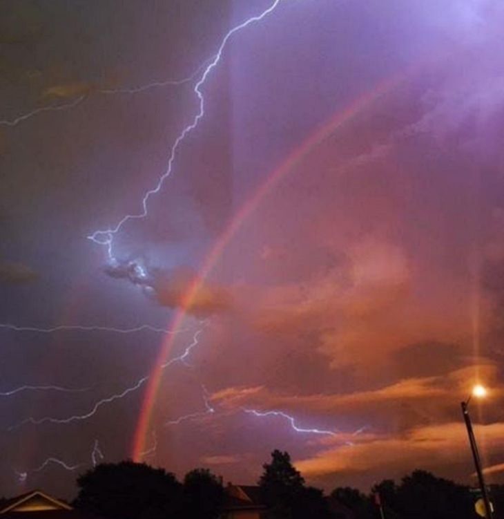 Photos showing the power and aftermath of natural disasters, lightning and rainbow visible in an orange sky during a storm in Texas