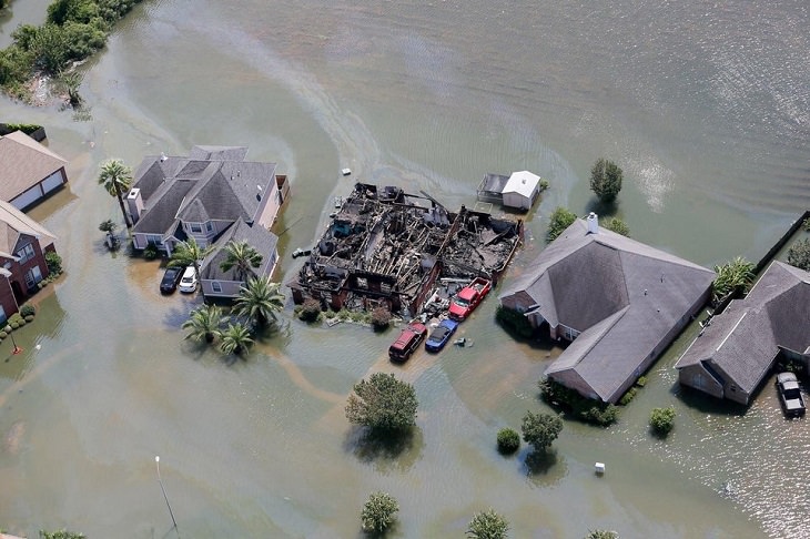 Photos showing the power and aftermath of natural disasters, houses submerged in a flood, one house burnt down