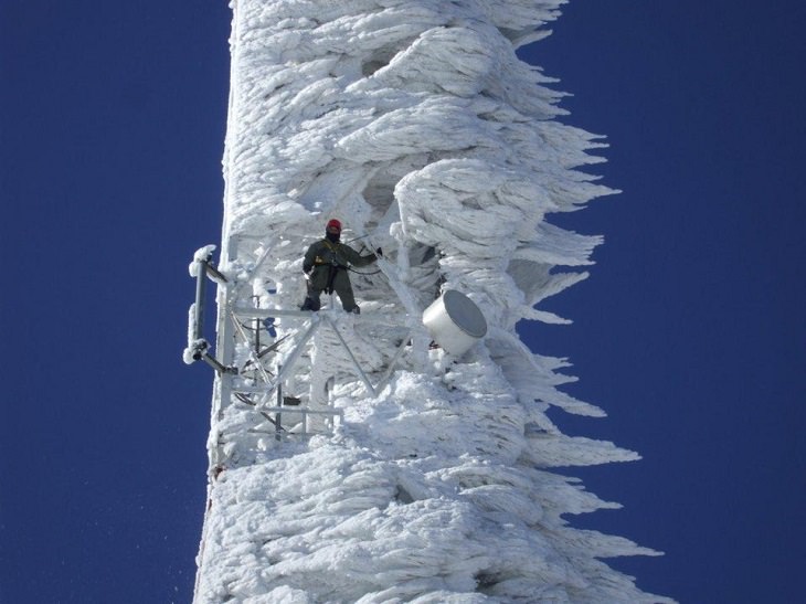 Photos showing the power and aftermath of natural disasters, a tower covered in snow and ice after a snow storm