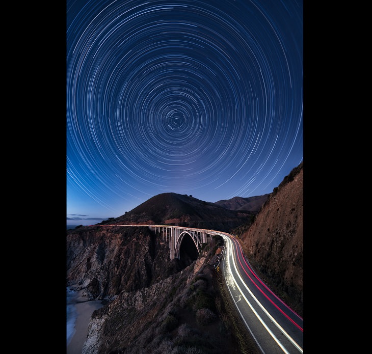 Astronomy photographs of the night sky and nightscapes by Marcin Zajac, In Motion, Cars zoom across Central California’s Bixby Bridge, as the night sky swirls around the North Star