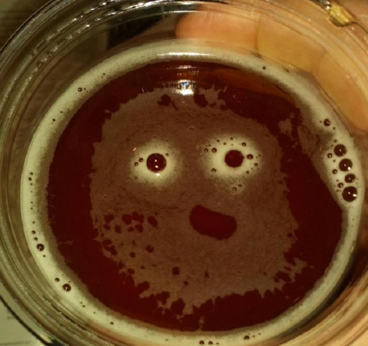 Everyday items with unexpected faces that, once seen, can never be unseen, drink in a glass with bubbles forming a smiling face