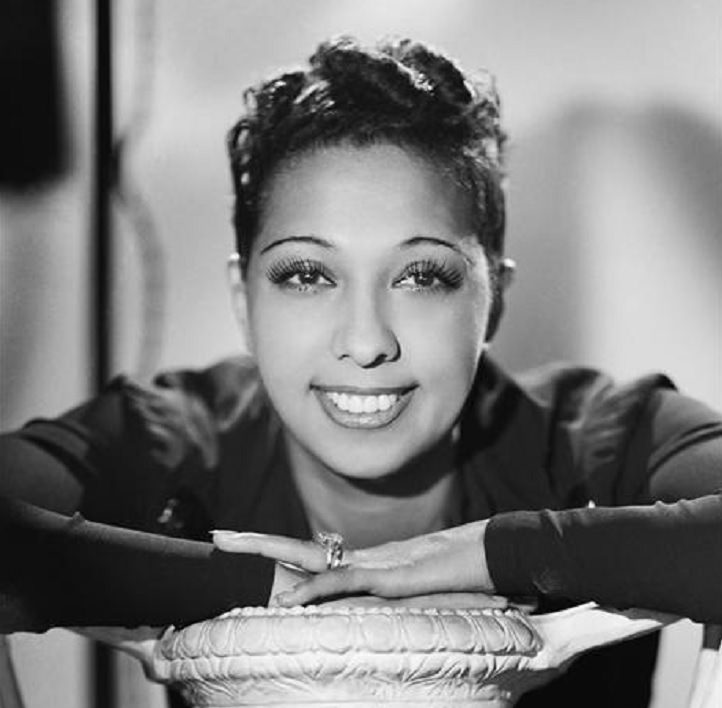 Josephine Baker: Siren of the Resistance, Studio photo of young Josephine Baker with her hands resting on a small table