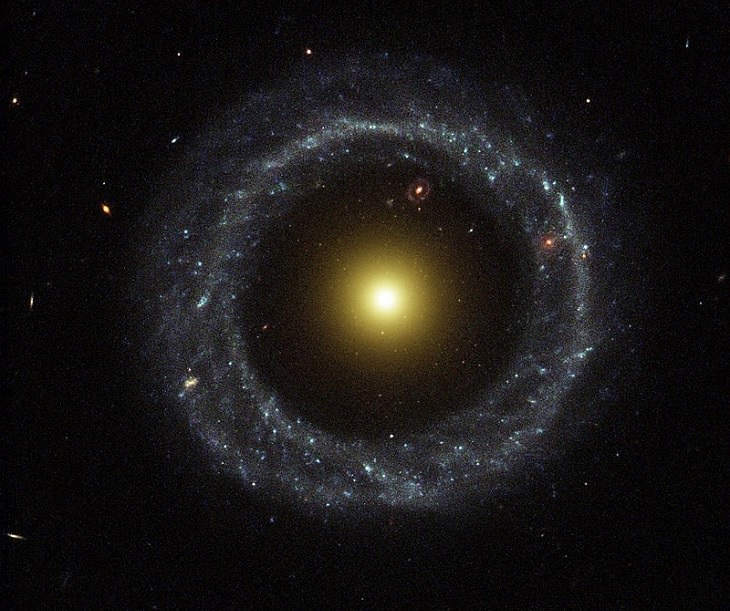 Photo gallery of the most unusual and strangely beautiful galaxies found in the universe and across space, Hoag’s Object, an unusual ring galaxy with a yellow nucleus