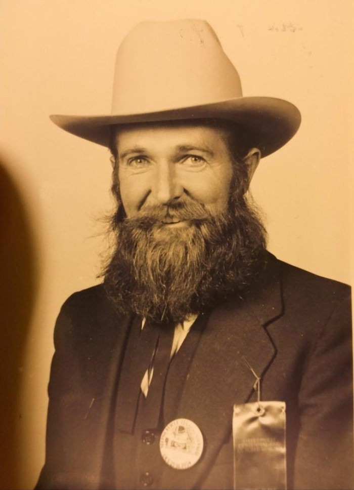 vintage photo man smiling with a beard and hat