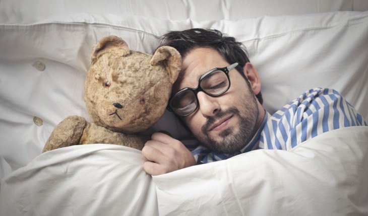 man sleeping with teddybear