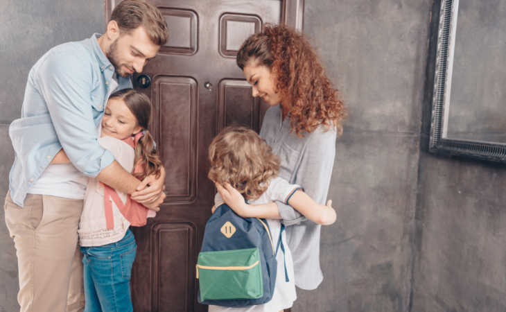 parents hugging school children 