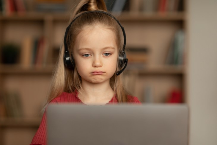 little girl sad watching laptop