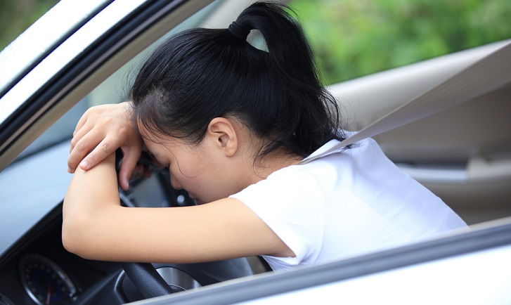 chinese woman in car despondant