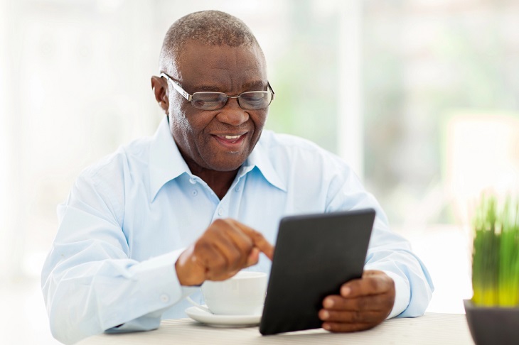mature man using tablet
