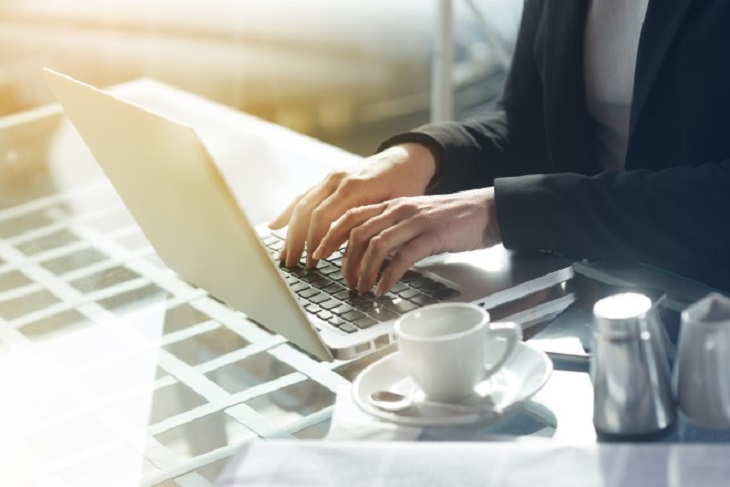 woman writing on laptop