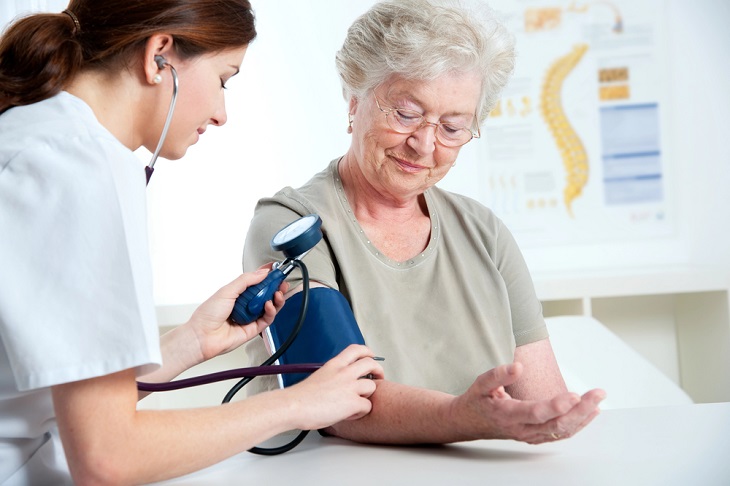 mature woman getting her blood pressure taken