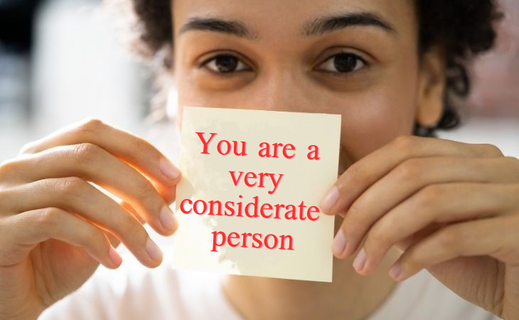 How to compliment your partner: A woman holding a note that says 'How could anyone be more considerate than you?'