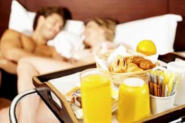 developing a more romantic soul: couple enjoying breakfast in bed