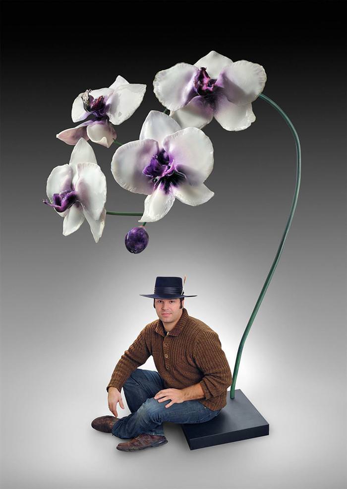 Jason Garmrath sitting under big glass orchids 