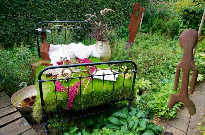 Recycled Furniture 4 post bed used to grow plants on as part of garden 