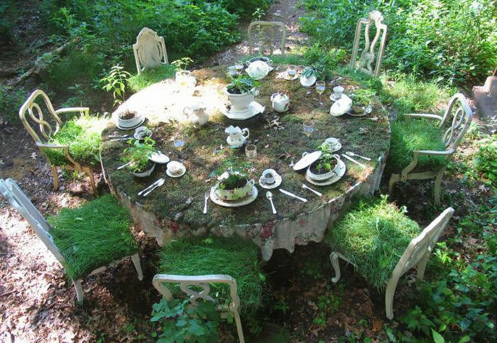 Recycled Furniture a round set table for eight used to grow plants in a garden