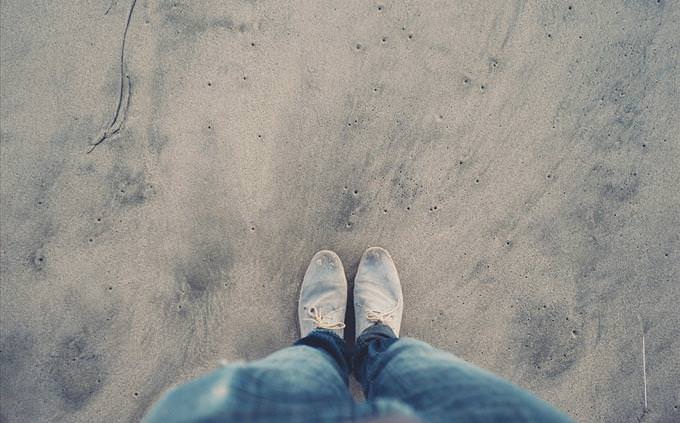 looking at shoes on beach