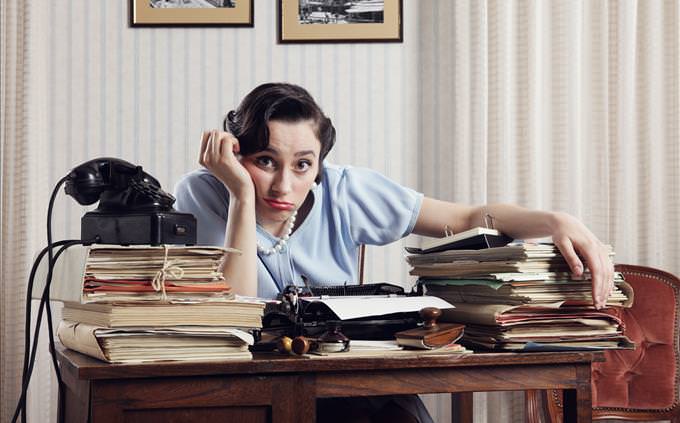 overwhelmed 1950s female office worker
