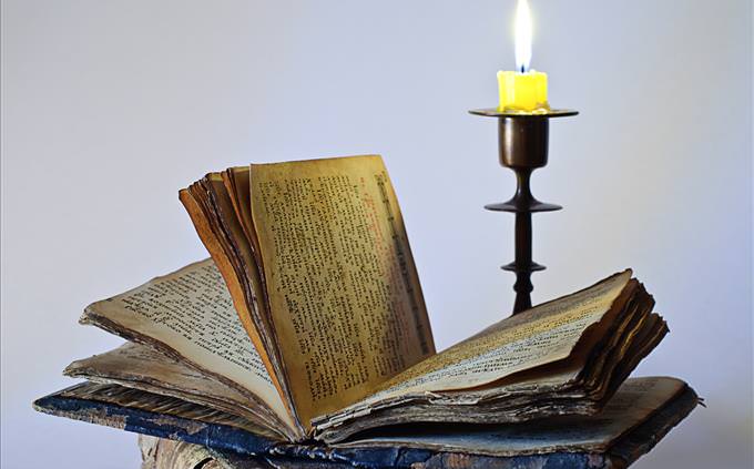 withered book beside candle
