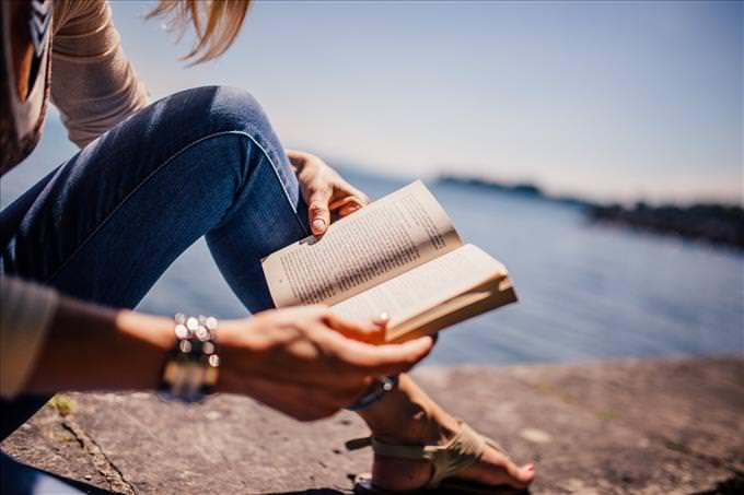 woman reading by the sea