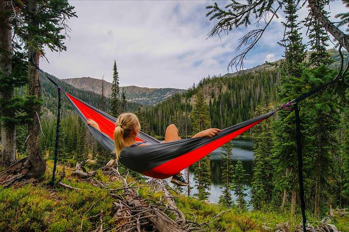 blonde woman in red hammock