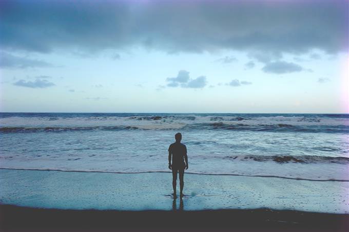 man standing on beach shore