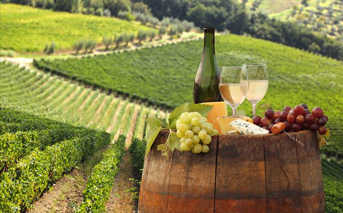 wine and grapes on a barrel