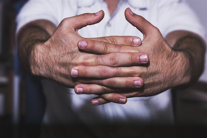 a man clasping his hands