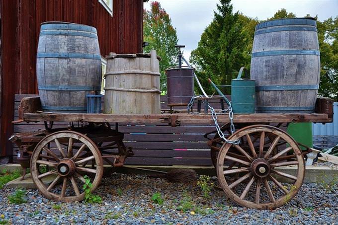 wooden carriage with barrels on it