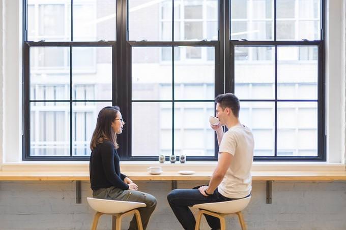 a man and a women having a cup of coffee together