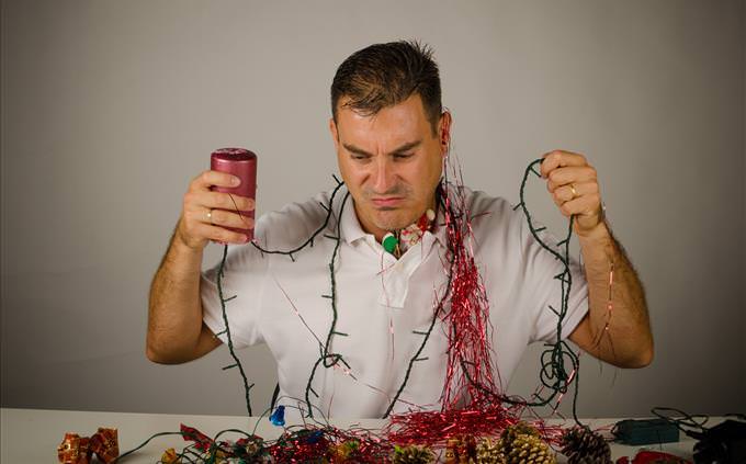 Frustrated man with Christmas decorations