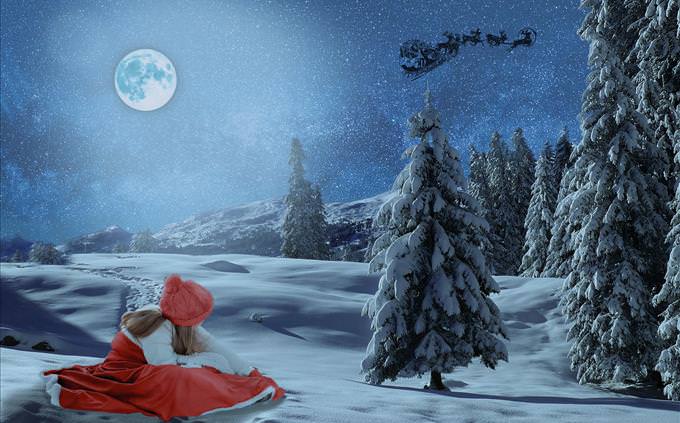 girl sitting in snow as Santa flies over her