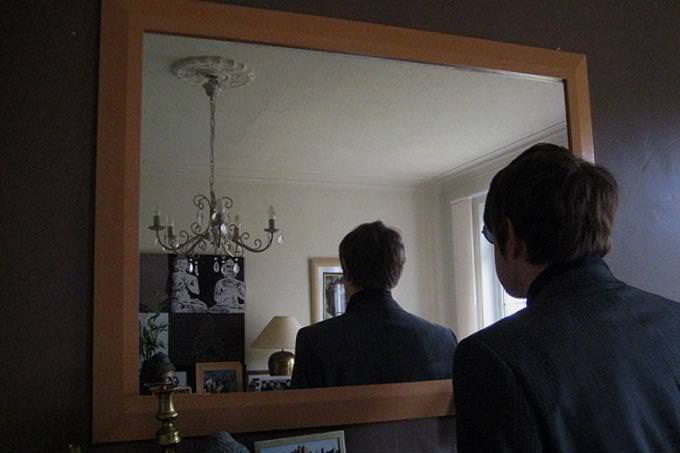 a man looking in  mirror