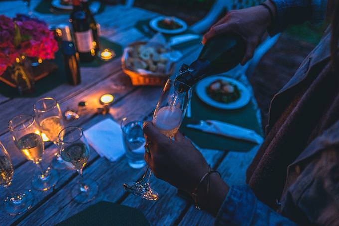 A woman pouring a glass of champagne