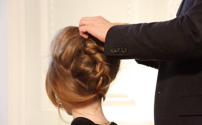 A man styling a woman's hair