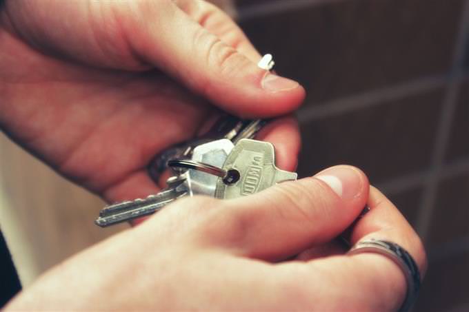 The hands of a man busy with a bunch of keys