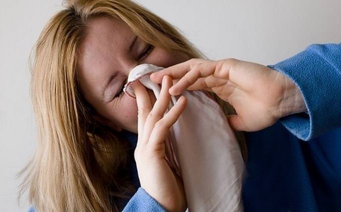 Woman blowing her nose