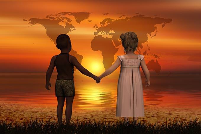 Computerized illustration of children standing in the sea facing the sunset