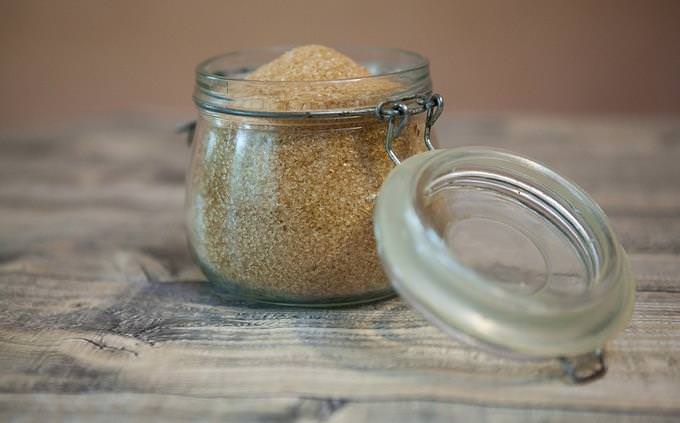 An open jar with brown sugar