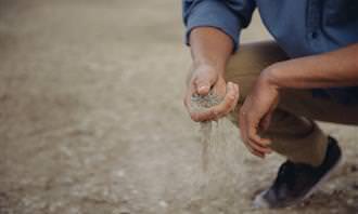 man holding sand