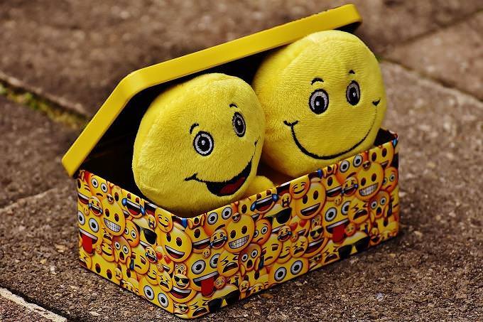 box with smiling dolls