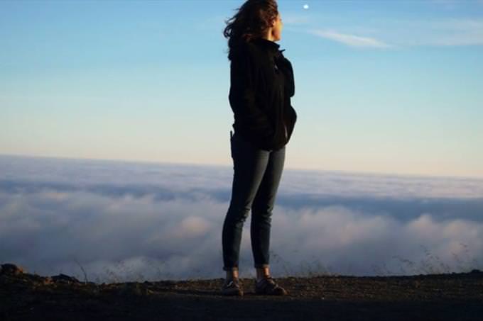 woman standing on mountain top