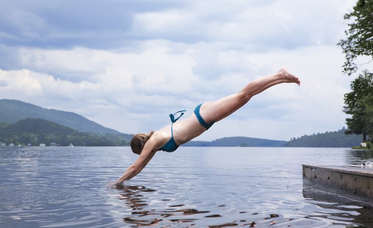 woman diving into lake