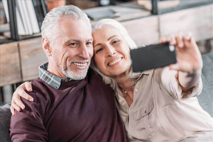 elderly couple taking a selfie