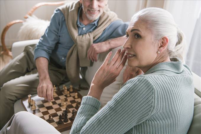 elderly couple playing chess