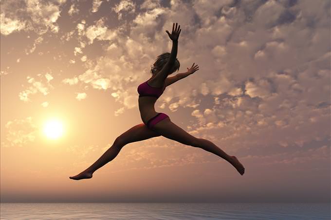 fitness woman jumping on beach