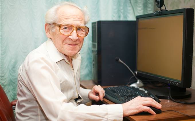elderly man using PC