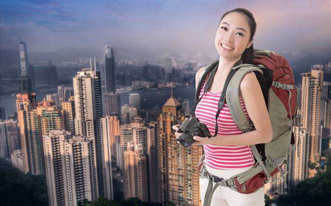 Asian tourist photographing skyscrapers