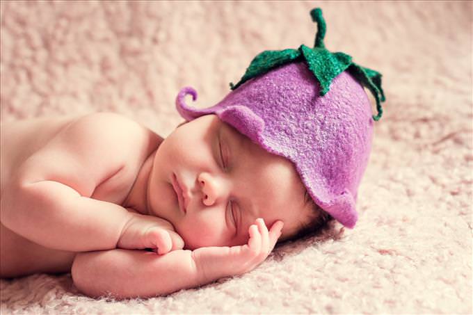 baby wearing pink hat