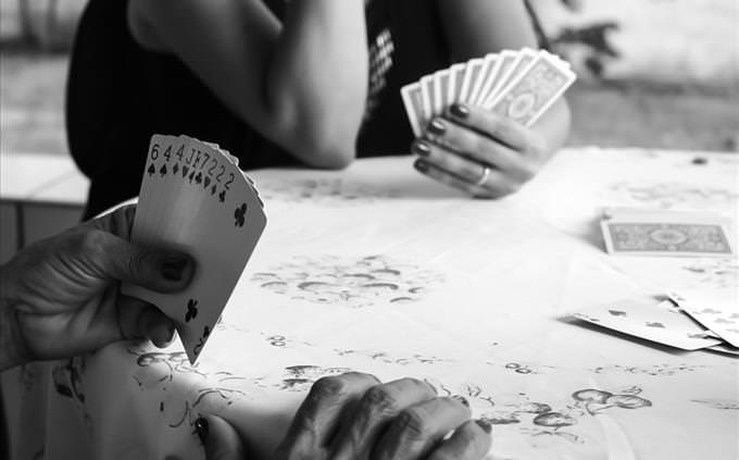 monochrome female card players